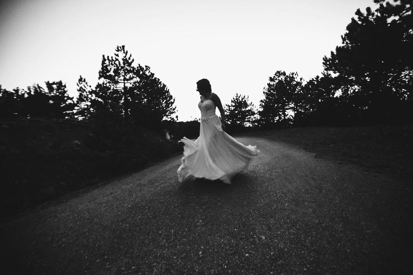Bride dancing on the road, black and white