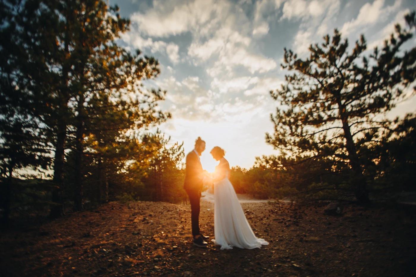 Couple in the forest at sunset
