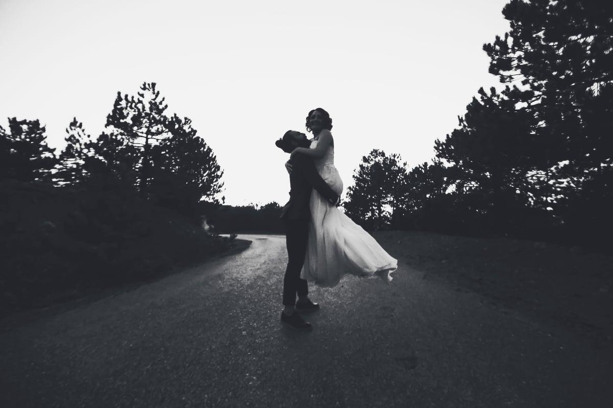 Couple embracing on the road, black and white
